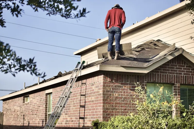 Professional roofer working on a residential roof in Fairview Corners